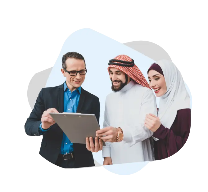 Bank representative discussing a personal loan in UAE with customers reviewing documents together